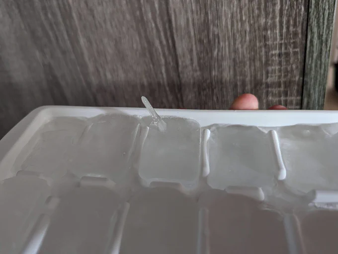 Photo of ice try but with one of the ice blocks having a protruding formation of sorts sticking out