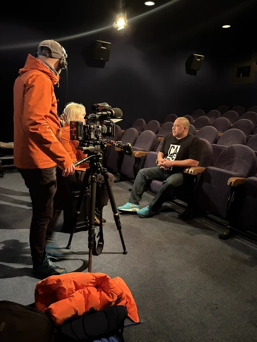 Man in cinema with camera crew