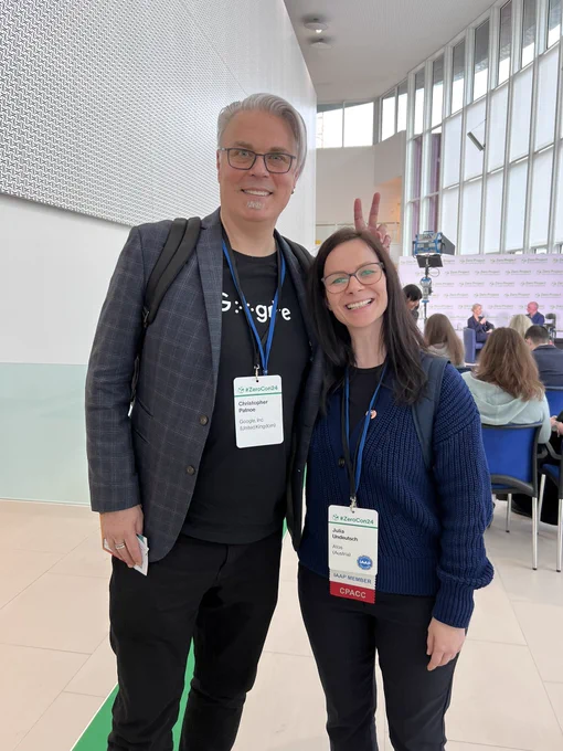 Christopher Patnoe and I standing next to each other smiling into the camera. He makes fun of me with bunny ears.