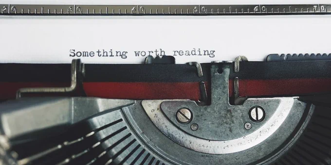 Black and Red Typewriter on White Table