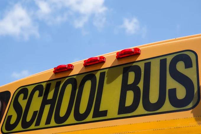 front top facing part of school bus with school bus across in big bold letters