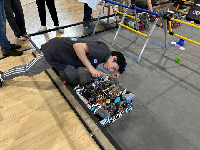 Students works on a robot before competition begins.