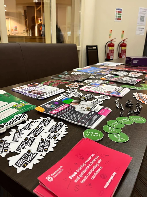 Raspberry Pi Foundation-related stickers and leaflets on a table at the Creative Tech Festival. 