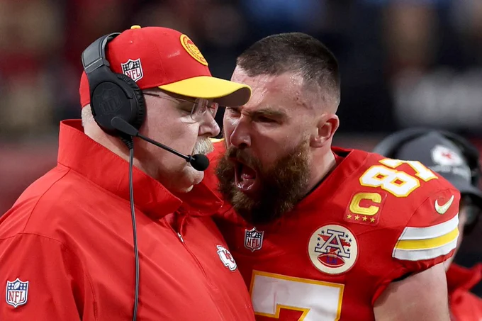Kansas City Chiefs football player Travis Kelce screams in the face of his coach during the Superbowl. The coach is wearing headphones.