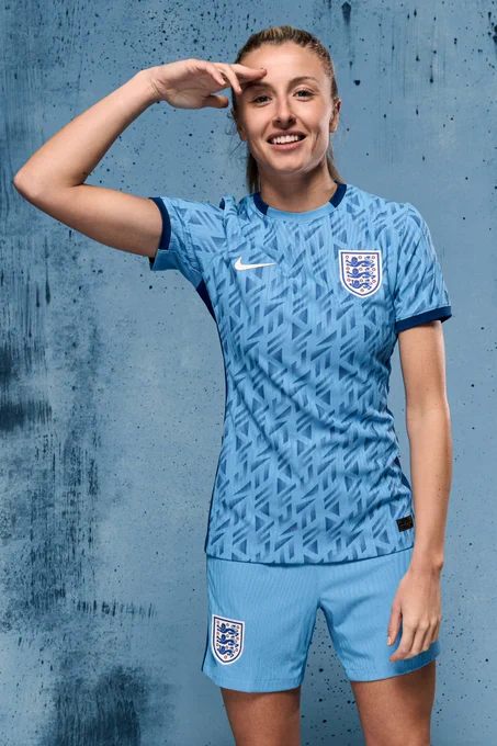 Leah Williamson photo in England away kit saluting. 