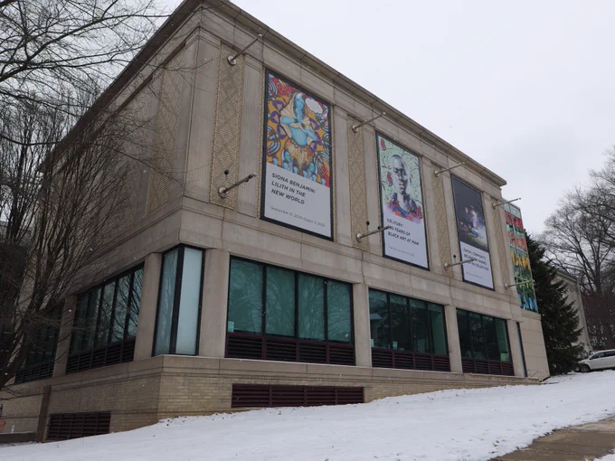 Snowy facade of the Montclair Art Museum's Bloomfield avenue facing wall. Three large posters face the street promoting new exhibitions at MAM. 