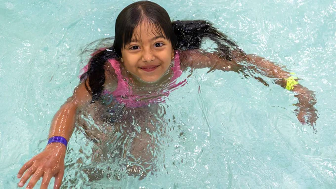 A child swimming in a pool.