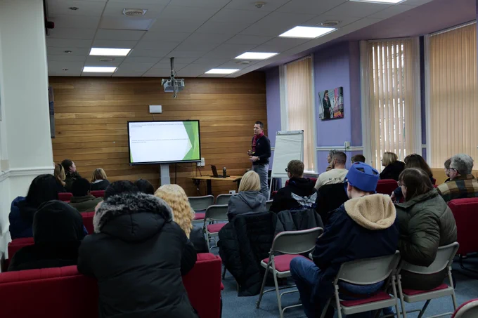 QAC Transition member of staff talking to students and families