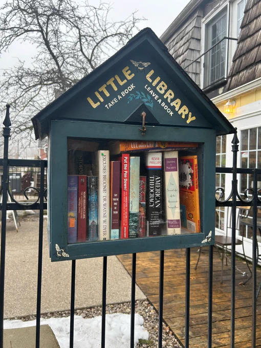 A Little Free Library box outside a shop