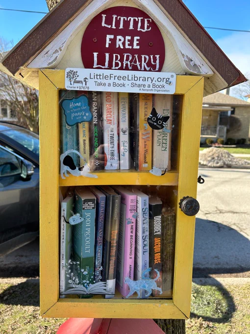 A Little Free Library box on a front lawn