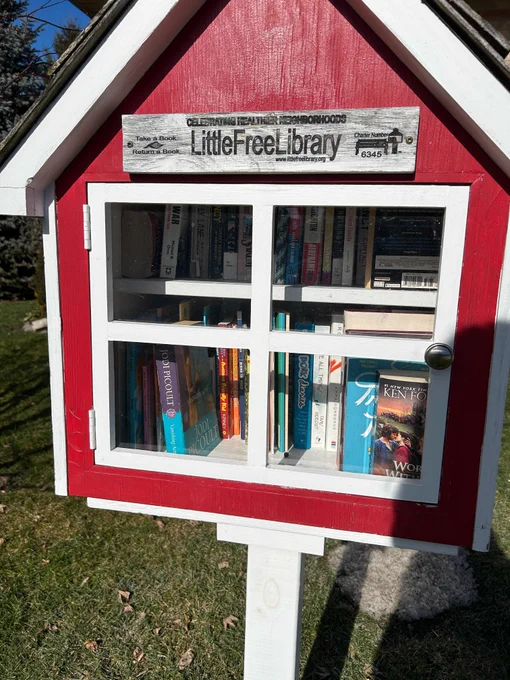 A Little Free Library box on a front lawn