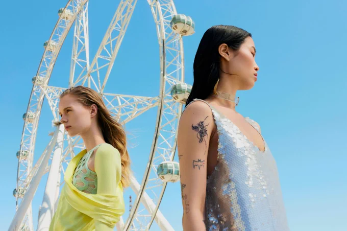 2 models wearing designs from Australian fashion designers under the ferris wheel 