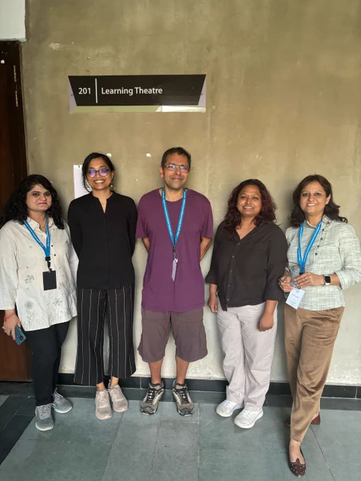 A group photo taken of the Raspberry Pi Foundation team in India, Shriram Krishnamurthi, and others attending the workshop. 5 adults standing under a sign that reads "Learning Theatre".