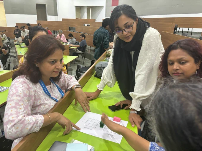 4-5 people in a group working together as part of a workshop.
