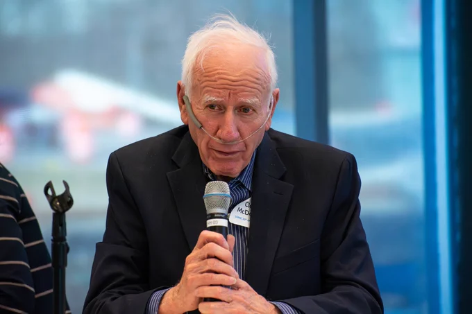 A photo of Clem McDonald, MD, Chief Health Data Standards Officer, National Library of Medicine speaking on a panel 