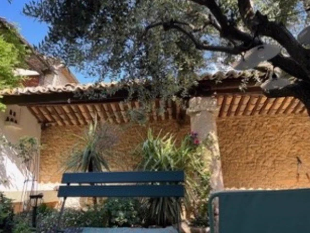 A walled courtyard and bench in sunny France 
