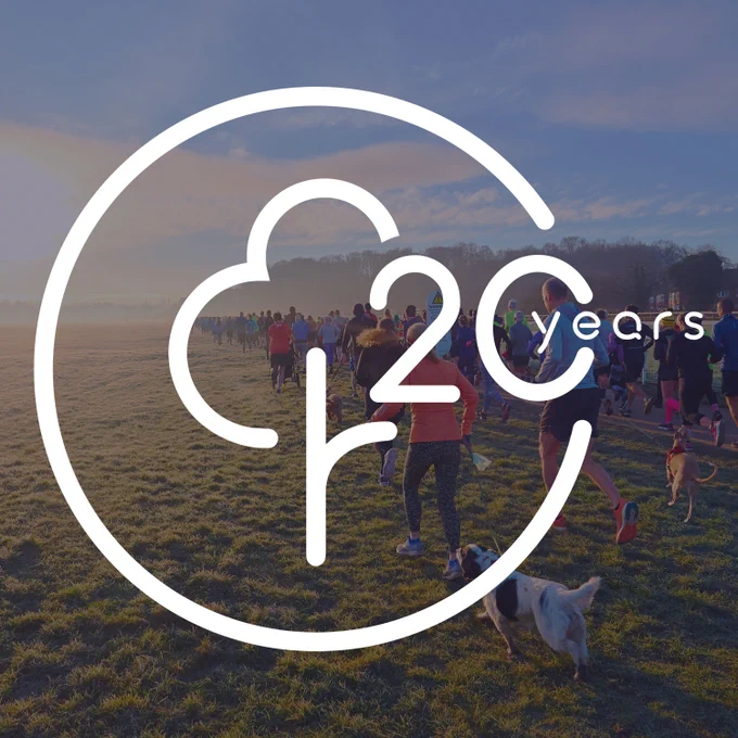 parkrun logo on a background image of parkrun event
