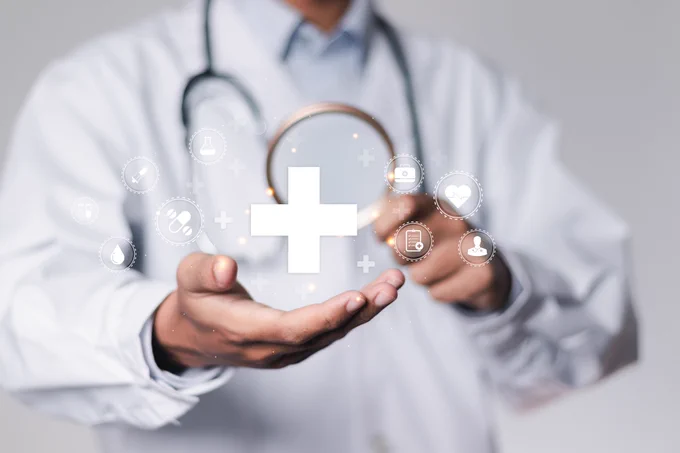 Graphic of a doctor with digital healthcare and medical technology icons on a virtual screen.