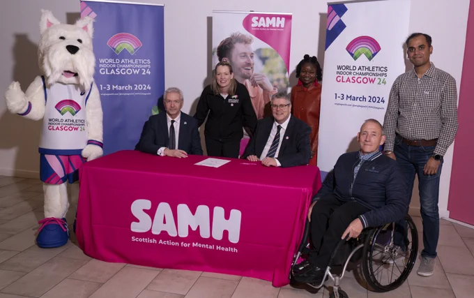 The championship mascot, Scottee, alongside Billy Garrett, Eilidh Doyle, Billy Watson and three event volunteers