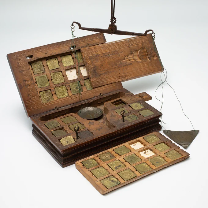 Boxed balance with weights
Germany, Cologne, 1699
Produced by Berndt Odental (weights) and 
Jacob Heuscher (balance). Courtesy of the American Numismatic Society, New York, 1930.179.1-24. Photography by Alan Roche.