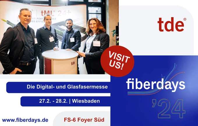 tde announcement as an exhibitor with their own booth at fiberdays 24 in Wiesbaden, Germany. In the foreground there are four tde employees in suits looking into the camera (from left: three male, one female) standing around a trade fair counter in front of the company's trade fair wall showing two product pics: the plug & play tde module tML24  and US Conec's MMC connector.