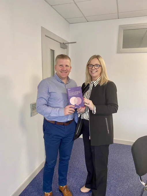NICCY Commissioner Chris Quinn and Parenting NI CEO Charlene Brooks holding a research paper.