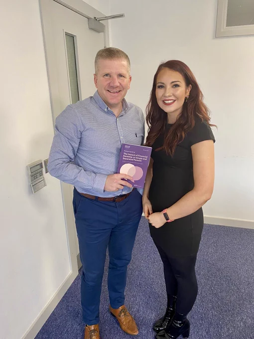 NICCY Commissioner Chris Quinn and Parenting NI Senior Participation and Research Officer Emma Hitchen holding a research paper.
