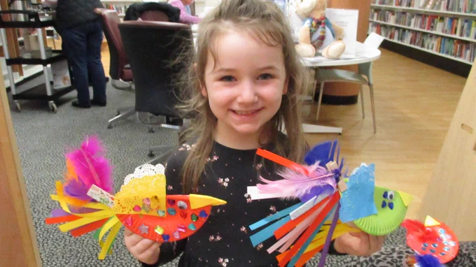 girl with colourful crafted birds