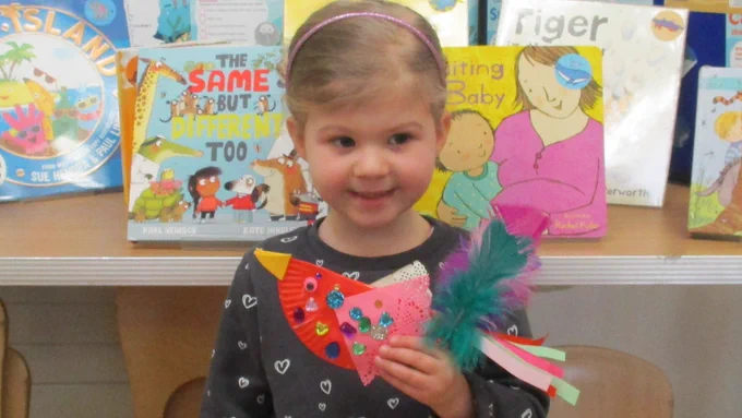 girl with colourful crafted birds