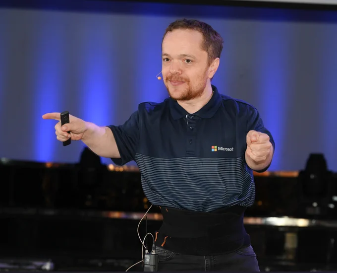 Rory Preddy presenting on a stage about #accessibility