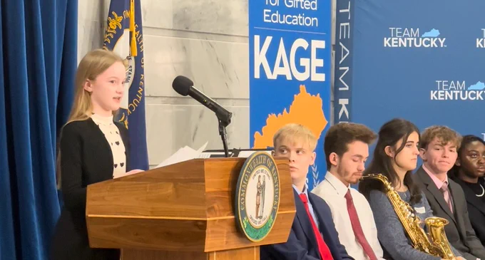 Lydia speaks at a podium.