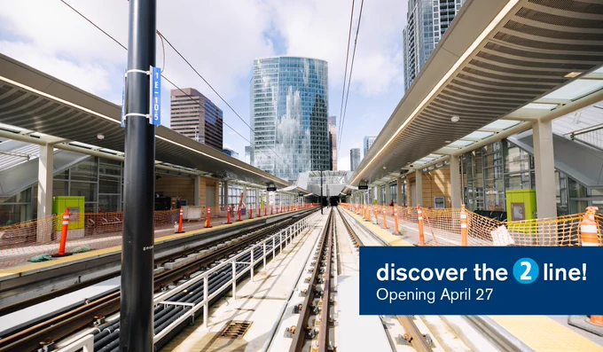 A shot of Bellevue Downtown Station. Text reads 'discover the 2 line! opening April 27'