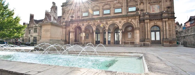 A fountain and statue sit in front of the York Art Gallery building