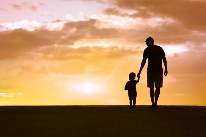 Father and son walking hand in hand