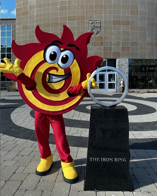 Flare poses beside the Iron Ring statue with its arms held out wide