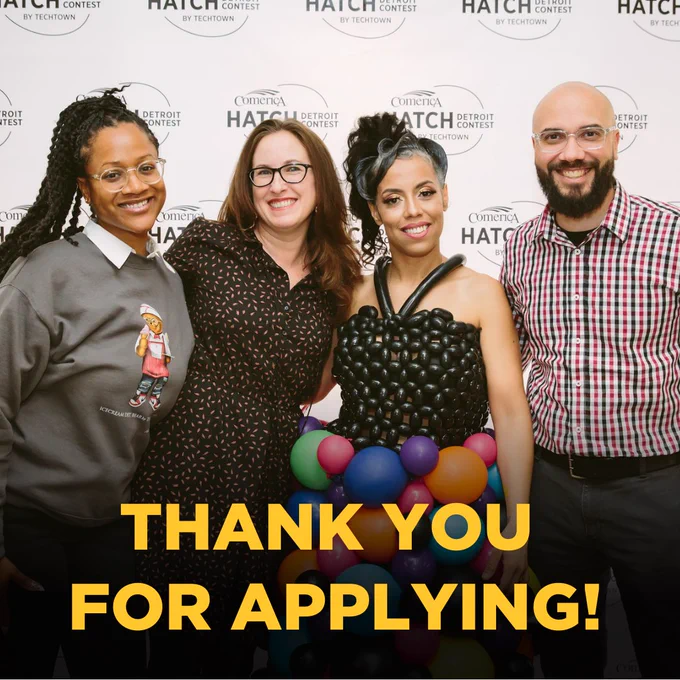 Four people standing together, celebrating the 2023 winner of the Hatch Detroit competition. The picture has text that writes, "Thank you for applying!". 