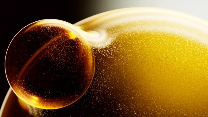 An amber bubble forming from a larger one
