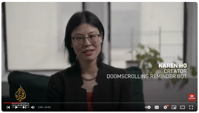 Karen K. Ho is sitting on her couch being interviewed by a documentary crew. The caption says "Creator, Doomscrolling Reminder Bot"