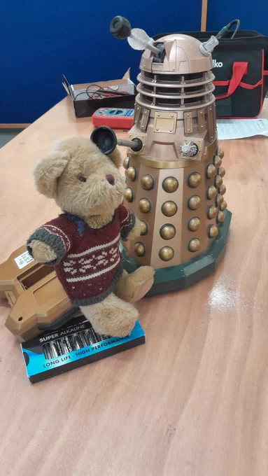 Repair Bear poses with a toy model Dalek. 