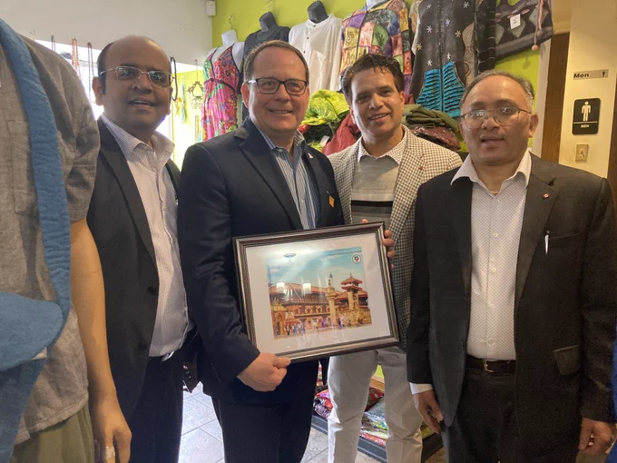 Mike standing with some board members and volunteers with Helping Hands