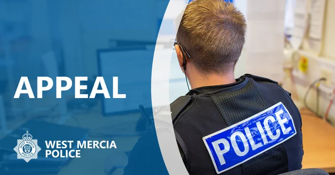 Back of police officer looking at a computer. 