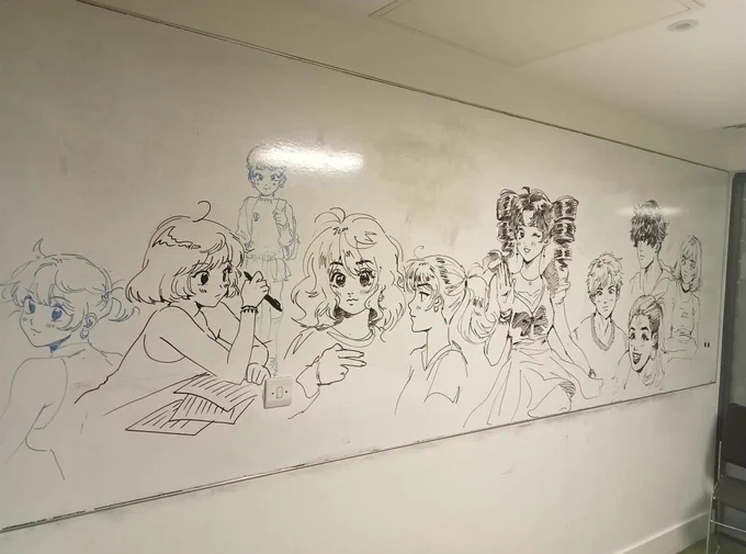 Image of an artist's Manga-style drawing of various people on a whiteboard