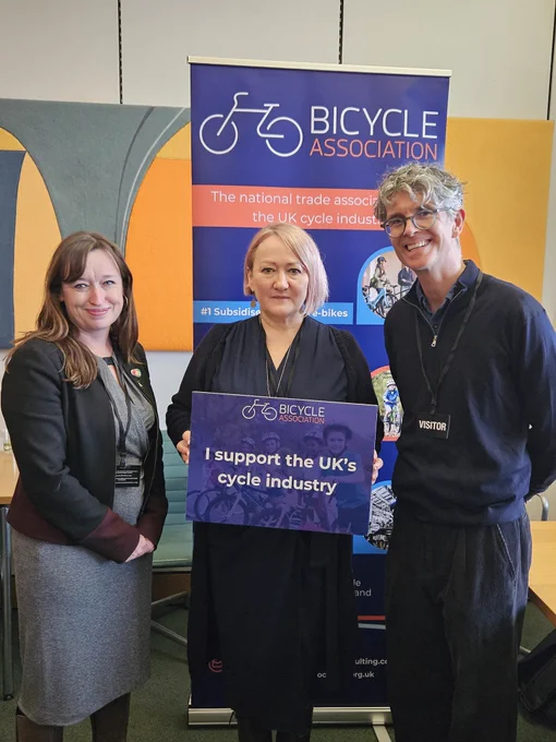 Emily Cherry, Kerry McCarthy MP, Lewis standing with sign 