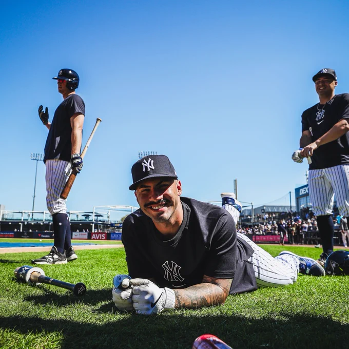 Gleyber Torres smiles laying on the grass before taking live BP. 