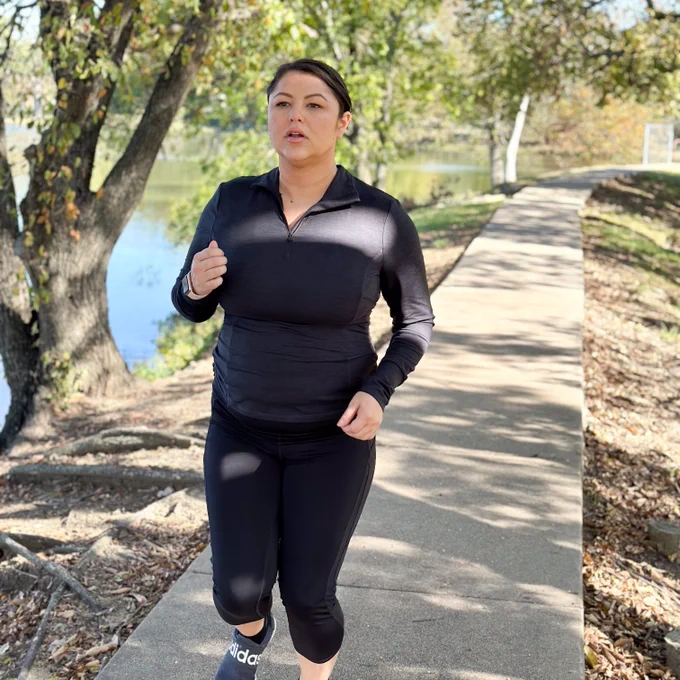 A photo of a woman on a run outside.