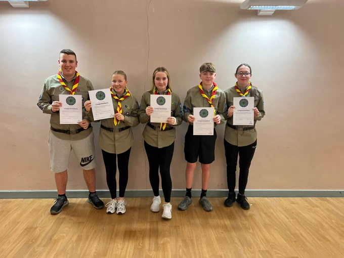 5 scouts holding certificates and wearing belts