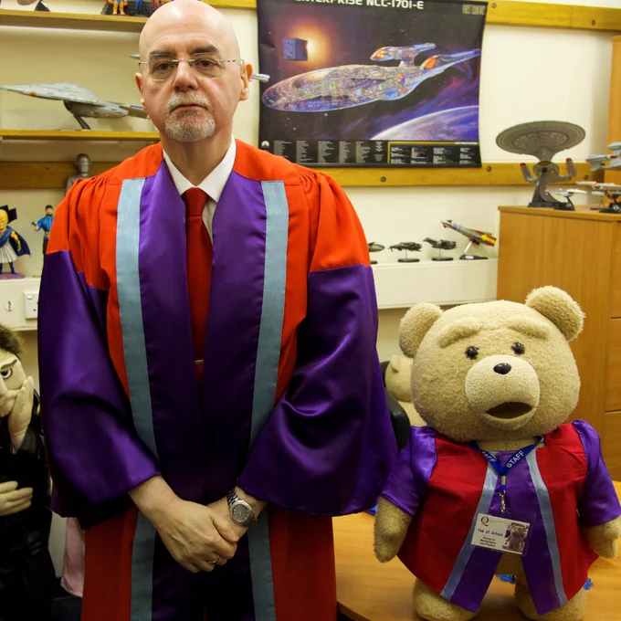 Image shows Professor Francis Keenan and Ted. They are both wearing Graduation gowns.