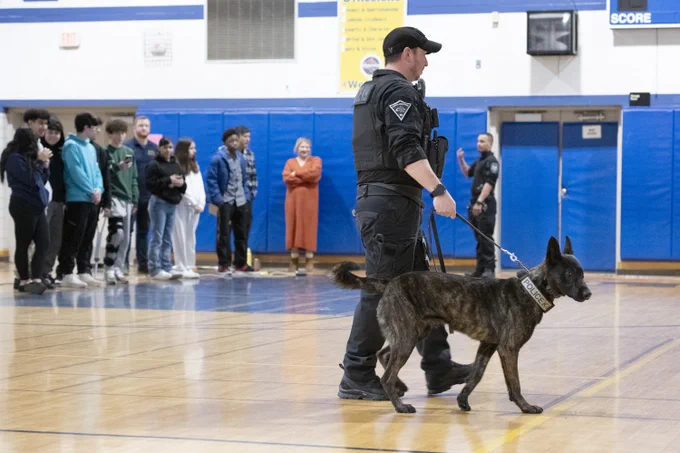 Canine unit officers in the gym during Career Day.