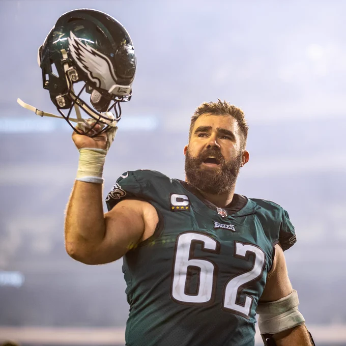 A photo of Jason Kelce holding up his helmet