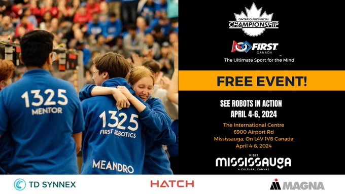 People hugging at a robotics event